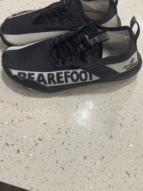 Black Slip-On Athletic Sneakers with White Side Stripe and Bold Side Text